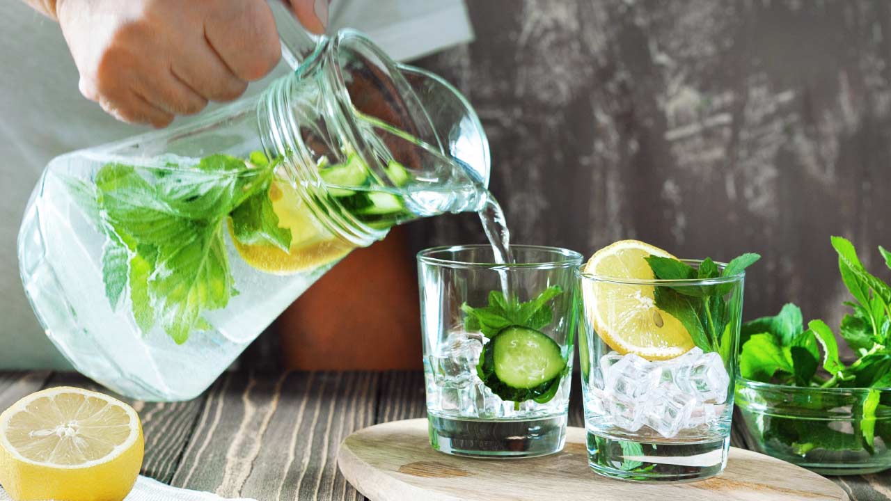 pouring lemon water for nutrition