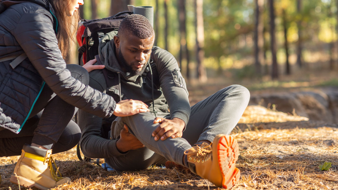 man and woman hiking and experiencing joint pain