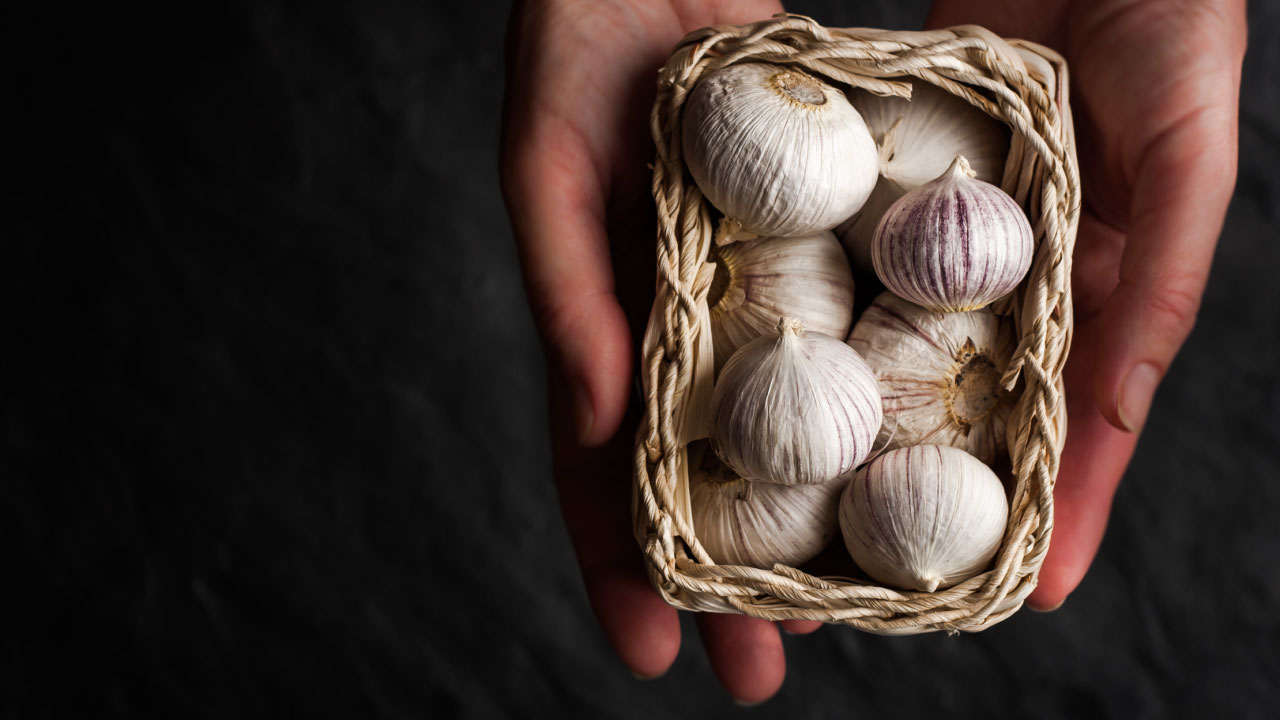 man holding garlic