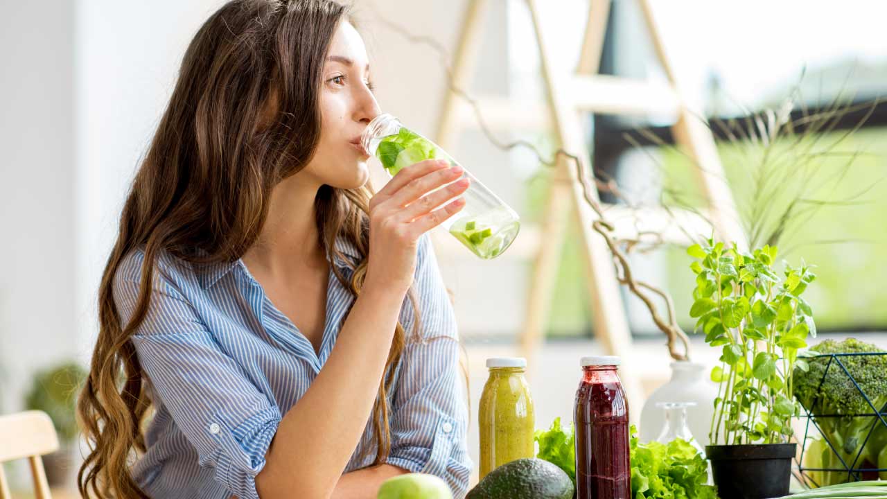 woman drinking water and cut the soda pop