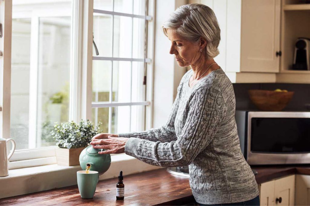 woman having cbd with her tea