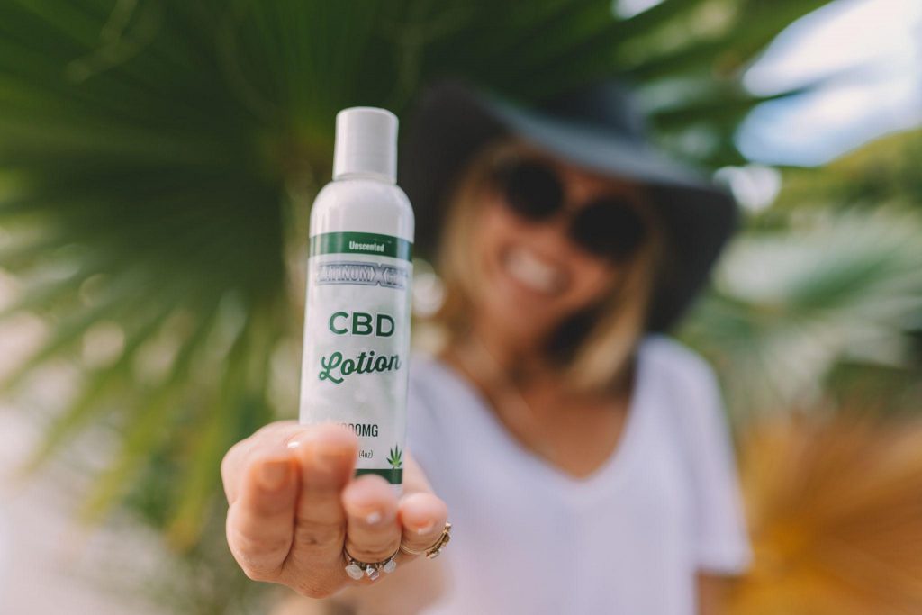 woman holding cbd lotion