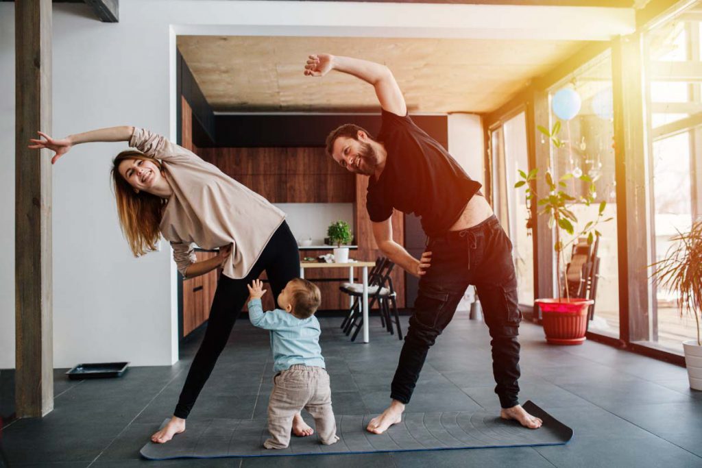 healthy man and woman exercising as family