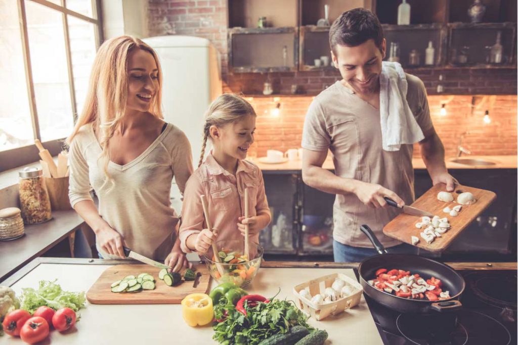 healthy family cooking a diet of vegetables