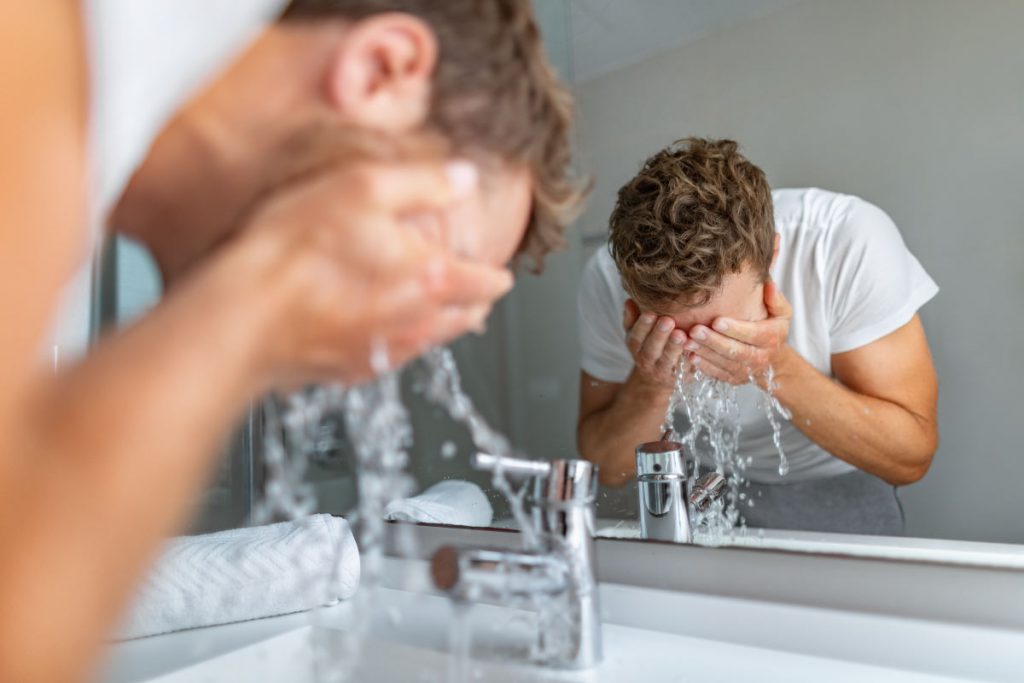 man exfoliating dry skin