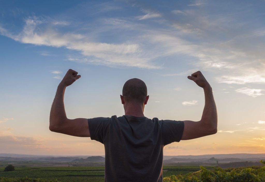 man flexing his testosterone in the wilderness