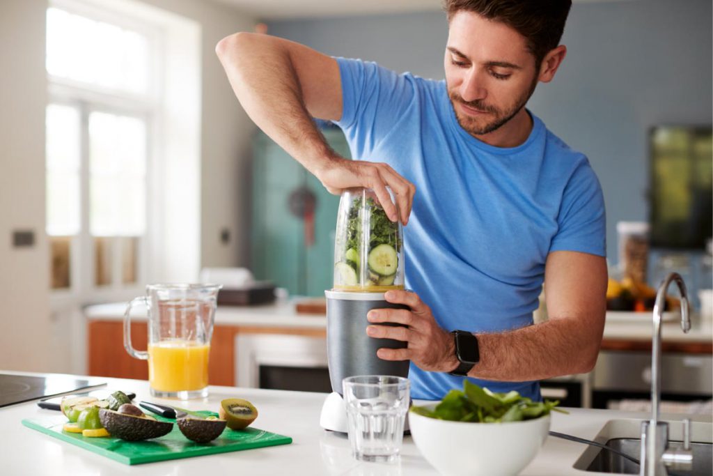 Man spring cleaning his body with a healthy smoothie