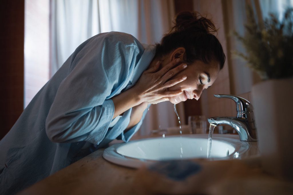 woman washing clear skin