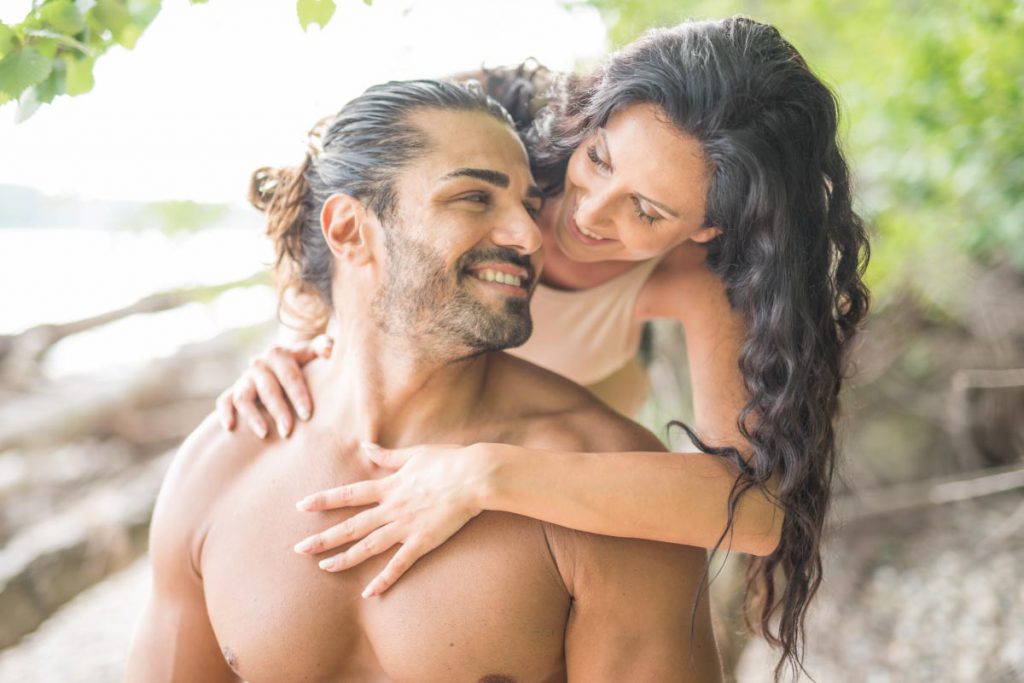 tan couple with full heads of hair enjoying a happy day on the beach after taking zinc