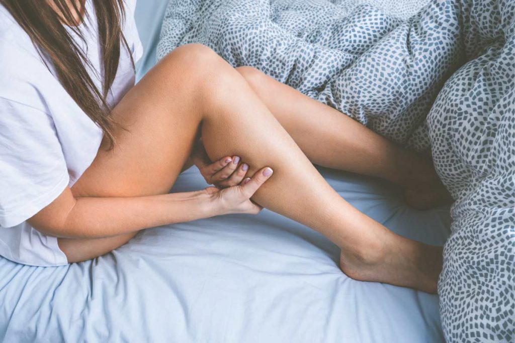 woman holding leg due to circulation issues