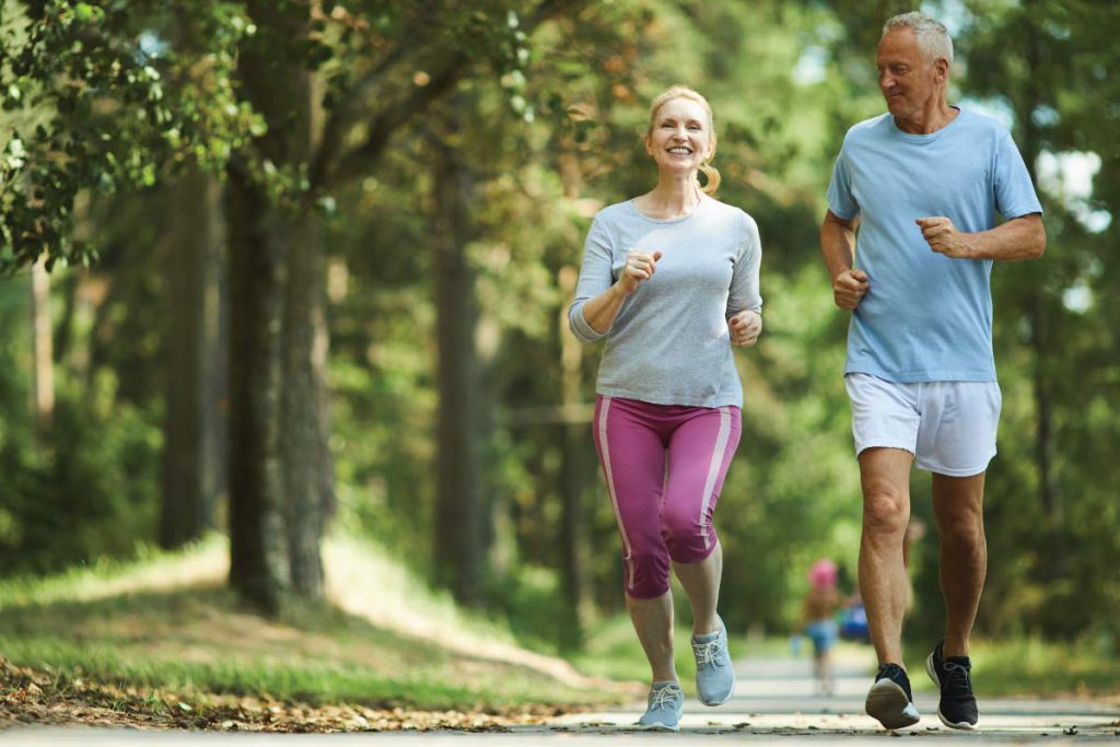 old healthy couple power walking